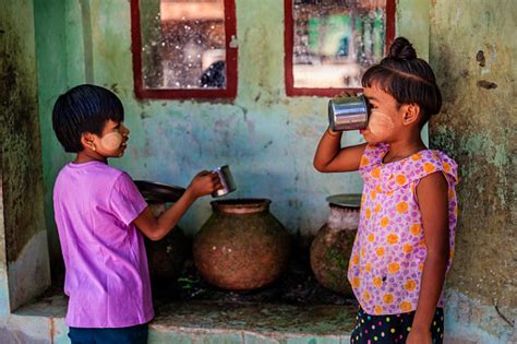 Little Burmese Girls Drinking Water In Village Near Bagan Myanmar Stock