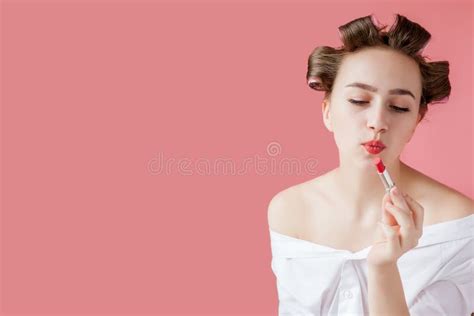 Closeup Portrait Of Beautiful Girl Putting On Red Lipstick Stock Image