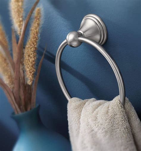 A Towel Ring On The Wall Next To A Blue Vase