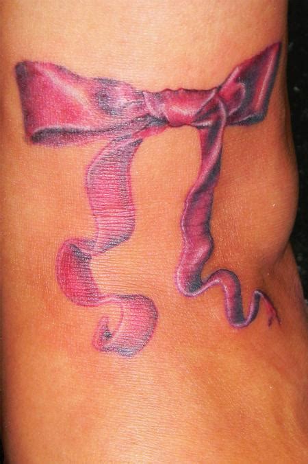 Winged ribbon tattoo on left shoulder. Ribbon Tattoos | Popular Tattoo Designs