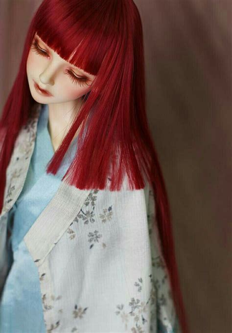 A Doll With Long Red Hair Wearing A Kimono