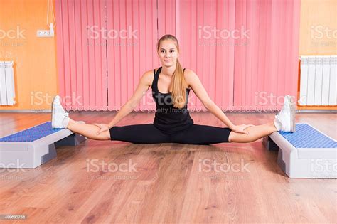 Woman Stretching Legs With Aerobic Step Platforms Stock Photo