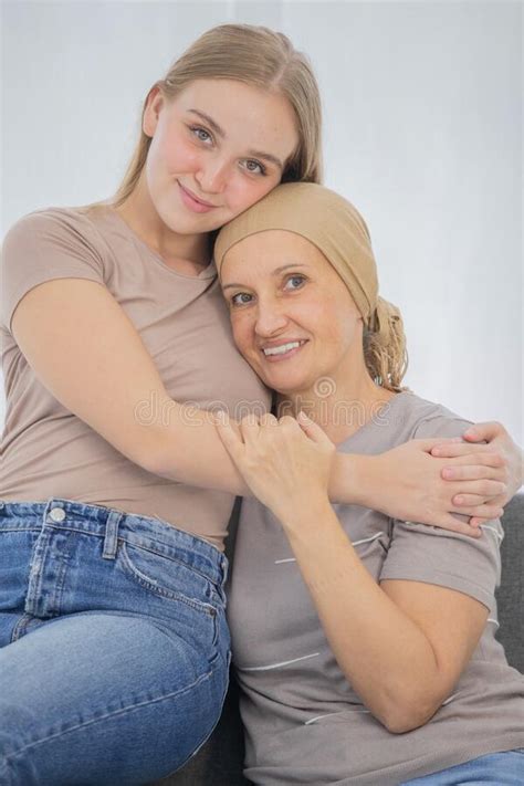 A Young And Beautiful Daughter Cuddles Her Mother`s Cancer Patient And