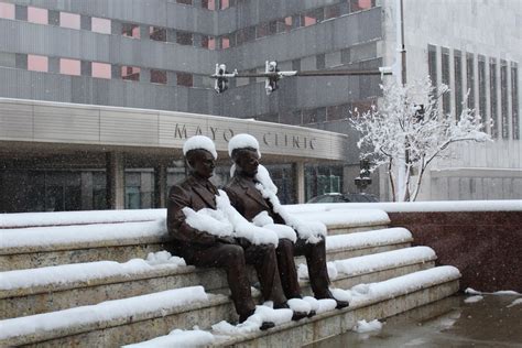 Snow Covered Statues Of The Mayo Brothers In Front Of The Mayo Clinic