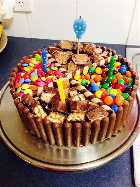 A Birthday Cake With Lots Of Candy And Candies On Its Bottom Layer