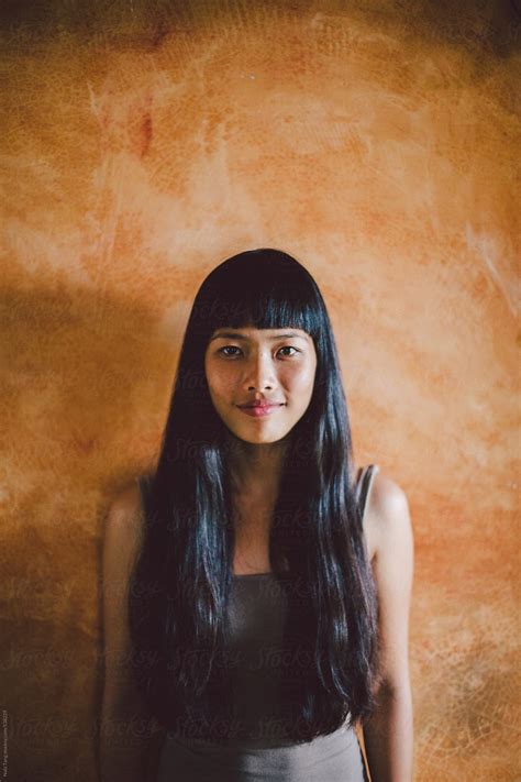 Asian Young Woman Portrait Smiling In Front Of Yellow Wall By Stocksy Contributor Nabi Tang