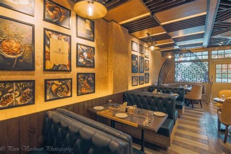 A Restaurant With Wood Paneling And Pictures On The Wall Along With