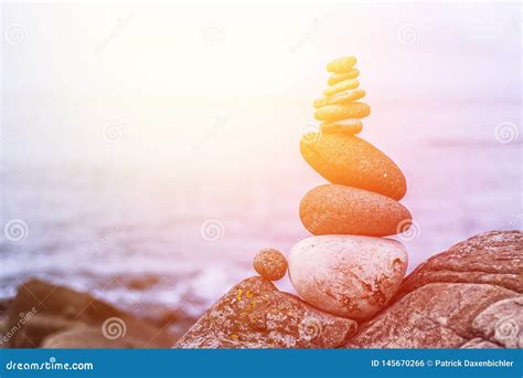 Balance Relaxation And Wellness Stone Cairn Outside Ocean In The Blurry Background Sunshine