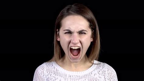 A Young Woman Shows Emotions Of Anger On Her Face Woman Screams In Anger On A Black Background