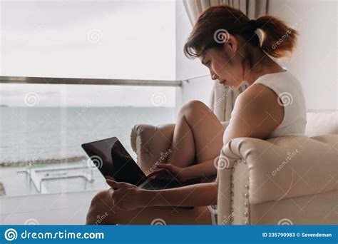 Woman Works And Relax With Laptop On The Sofa Concept Of Work From Hotel Stock Image Image