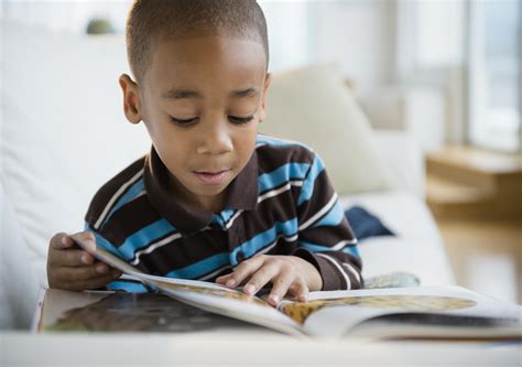 African American Boy Reading Book On Sofa 979 The Box
