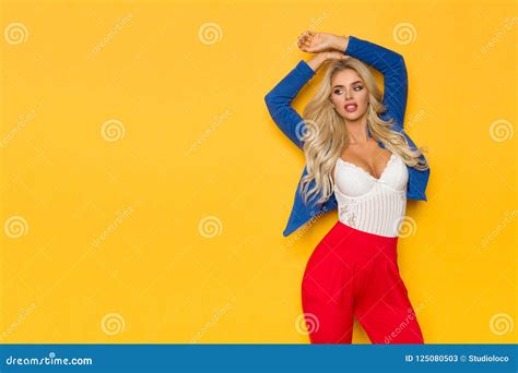 Beautiful Blond Woman In Blue Unbuttoned Jacket Is Posing With Arms