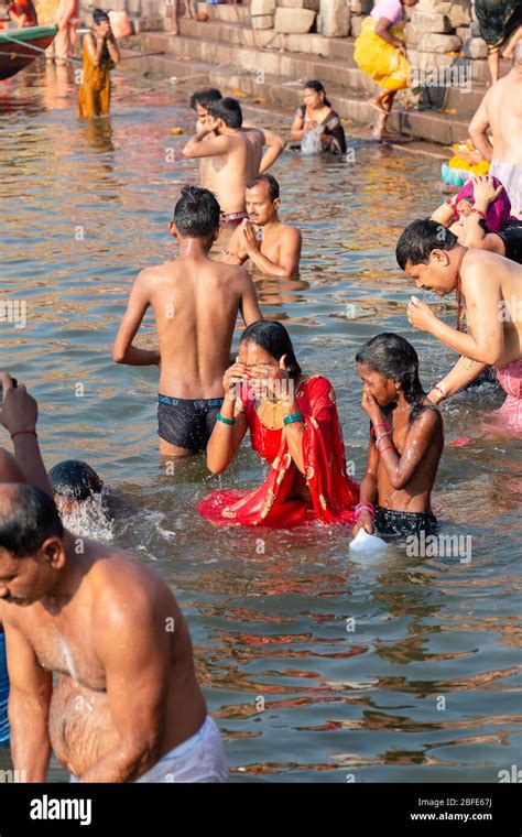 Pilgrims Bathing In Holy Ganges River At Sunrise In Varanasi India