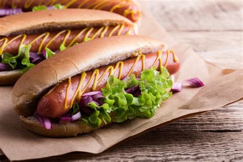 Hot Dog With Yellow Mustard Lettuce And Onions Stock Photo Image Of
