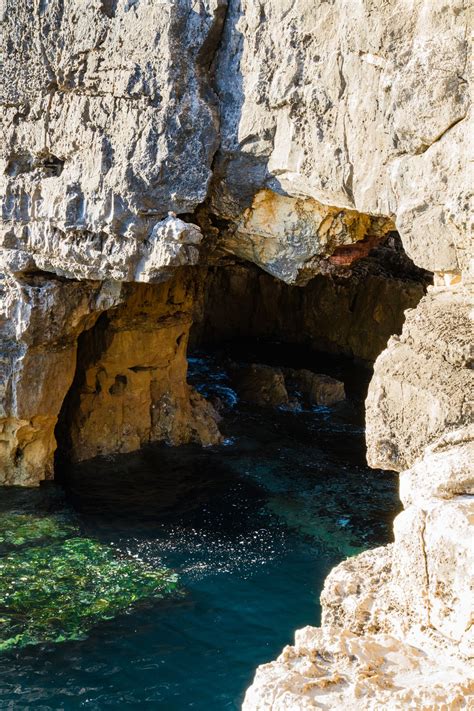 Gray Cave In Body Of Water Photo Free Cave Image On Unsplash