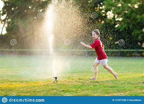 Kids Play With Water Child With Garden Sprinkler Stock