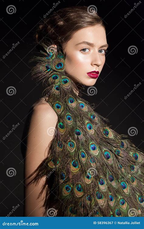 Incredible Fashion Beauty Portrait Of Attractive Girl Model With Peacock Feathers Stock Image