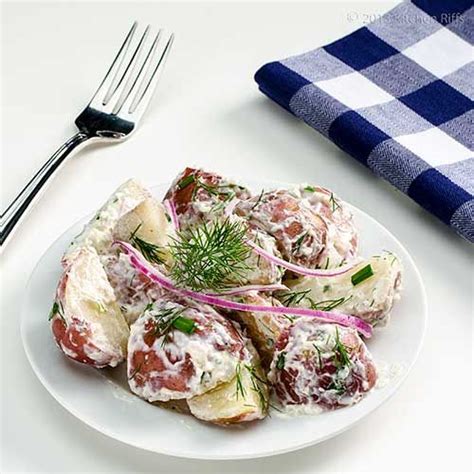 Horseradish Potato Salad On Plate With Dill And Red Onion Garnish