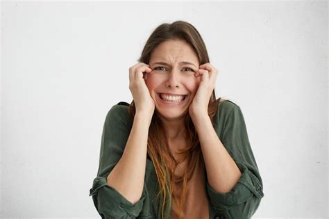 free photo scared woman having unpleasant expression frowning her face clenching her teeth