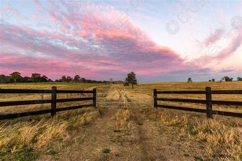 Colourful Sunset Over Country Fence And Gate In Rural Setting Stock