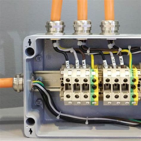 An Electrical Box With Multiple Wires Connected To It And Three Orange