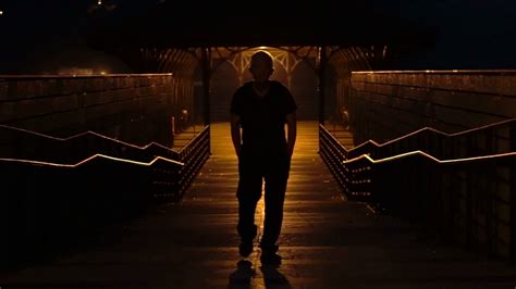 Silhouette Senior Man Walking Alone In Dark Night Orange Light From