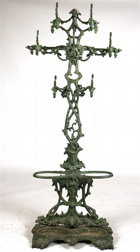 It looks art deco to me, but i'm not sure if i can describe it that way. Green Painted Cast Iron Hall Tree