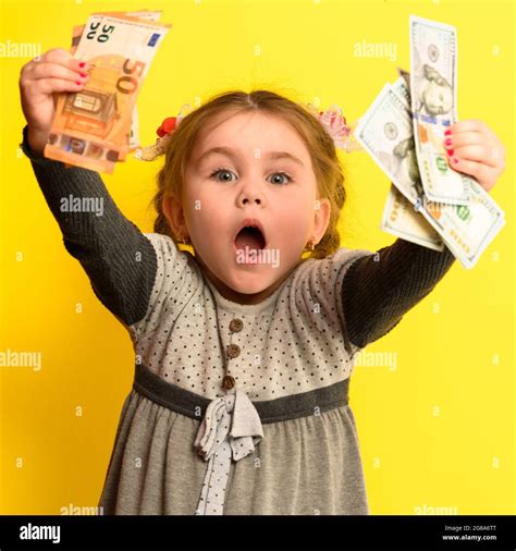 A Beautiful Girl Is Surprised By So Much Money A Child And Big Money
