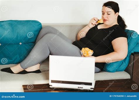 Obese Woman Sitting On Sofa Eating Unhealthy Food Stock Photo Image Of Health Addiction
