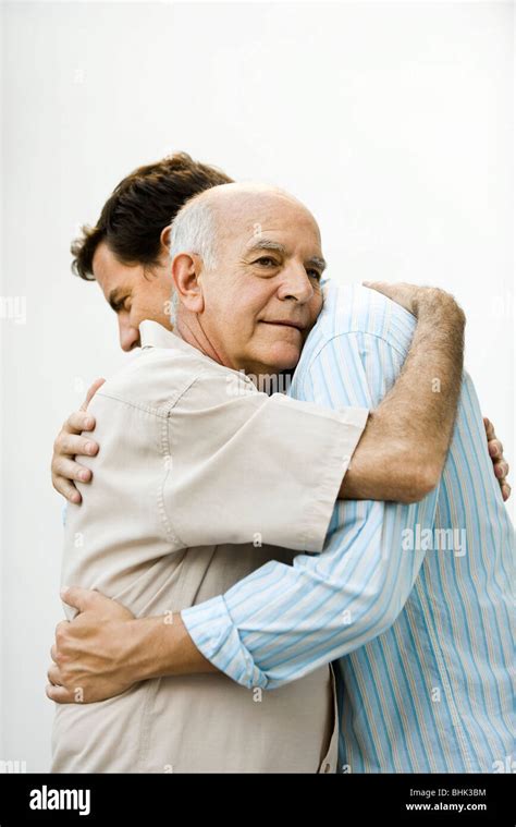 Senior Man Embracing Adult Son Stock Photo Alamy