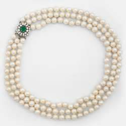 A Three Strand Cultured Pearl Necklace Clasp With Cabochon Cut Emerald Circa Cts And