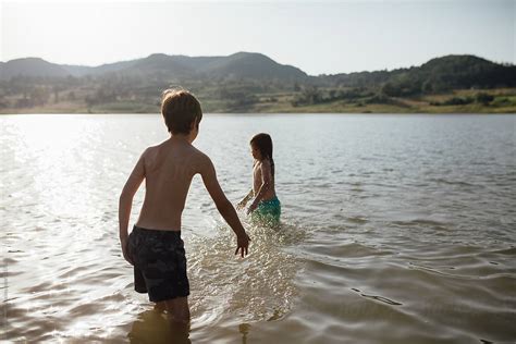 Young Boys Swimming In Lake By Stocksy Contributor Boris Jovanovic