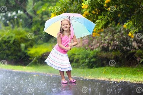 Kid With Umbrella Playing In Summer Rain Stock Photo Image Of Dance