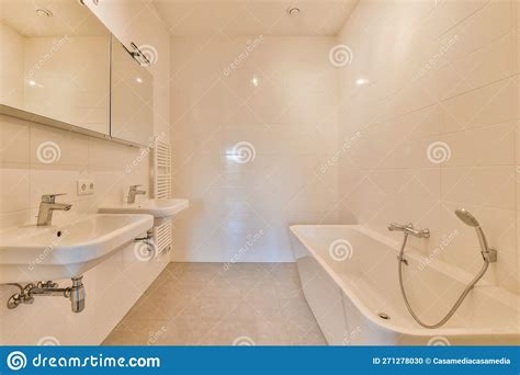 A Bathroom With A Tub And Sinks And A Mirror Stock Photo Image Of
