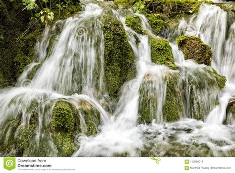 Small Waterfall Flows Over Moss Covered Stones In Plitvice Lakes Np