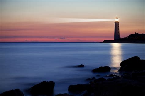 A Lighthouse On The Coast At Sunset Studer Education