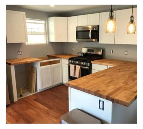 In addition to the daily cleaning routine, you can protect your butcher block kitchen countertops a few other ways. White Shaker style cabinets with Birch butcher block ...