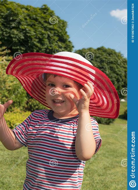 A 3 Year Old Boy In A Red Hat And A Striped T Shirt Happy Childhood In
