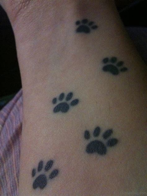 Here are 33 pawprint tattoo ideas to celebrate your best furry friend and all the love you have for them! 35 Pretty Paw Print Tattoos For Wrist