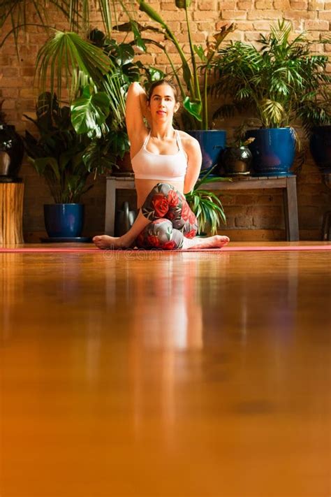 Slim Young Woman Practicing Yoga In Studio Asana Garudasana Stock