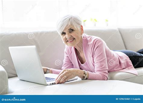 Retired Senior Woman Sitting At Home Using Her Laptop Stock Image Image Of Mature Casual