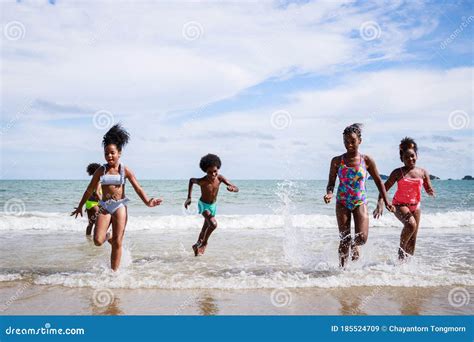 African American Kids Group In Swimwear Enjoying Running To Play The