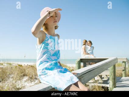 Preteen Girl Sitting On Beach With Barefeet Hugging Knees Stock Photo Alamy