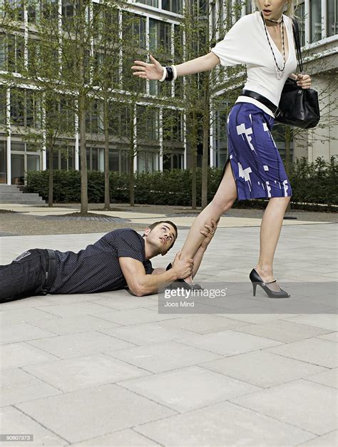 Man Holding Onto Womans Leg As She Walks Away Photo Getty Images