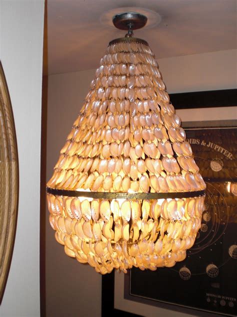 Heather kendall describes a custom designed, oyster shell mirror, in manasotta key, fl. oyster shell chandelier | Diy chandelier, Shell chandelier ...