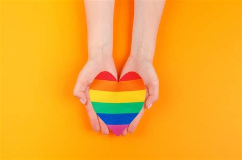 Premium Photo Gay Love Human Hand Holding A Rainbow Paper Heart