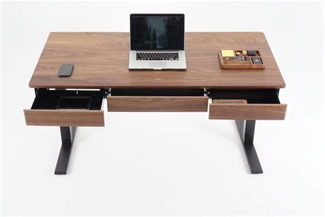 With some clever and creative cuts of plywood, you can make this brilliant table top standing desk topper. Wooden Smart Desk by Sean Woolsey Studio | Old News Club