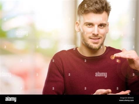 Handsome Young Man Holding Something Size Concept Stock Photo Alamy