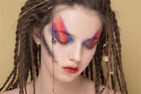 Close Up Fashion Female Model With Colorful Abstract Makeup And Dreadlocks Hairstyle Stock Image