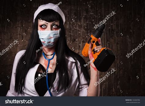 Crazy Dead Nurse With Electic Drill In The Hand In A Dark Room Stock